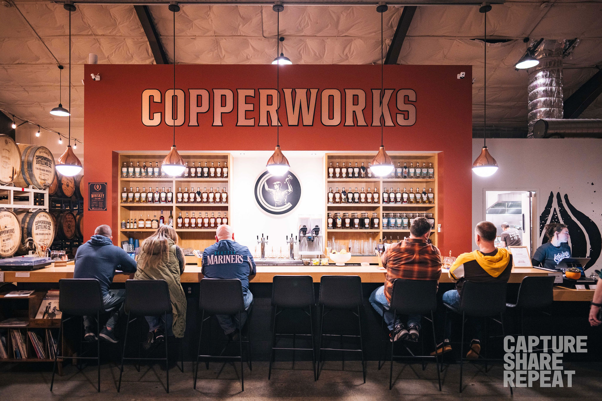 Bar view with people sitting at the bar.